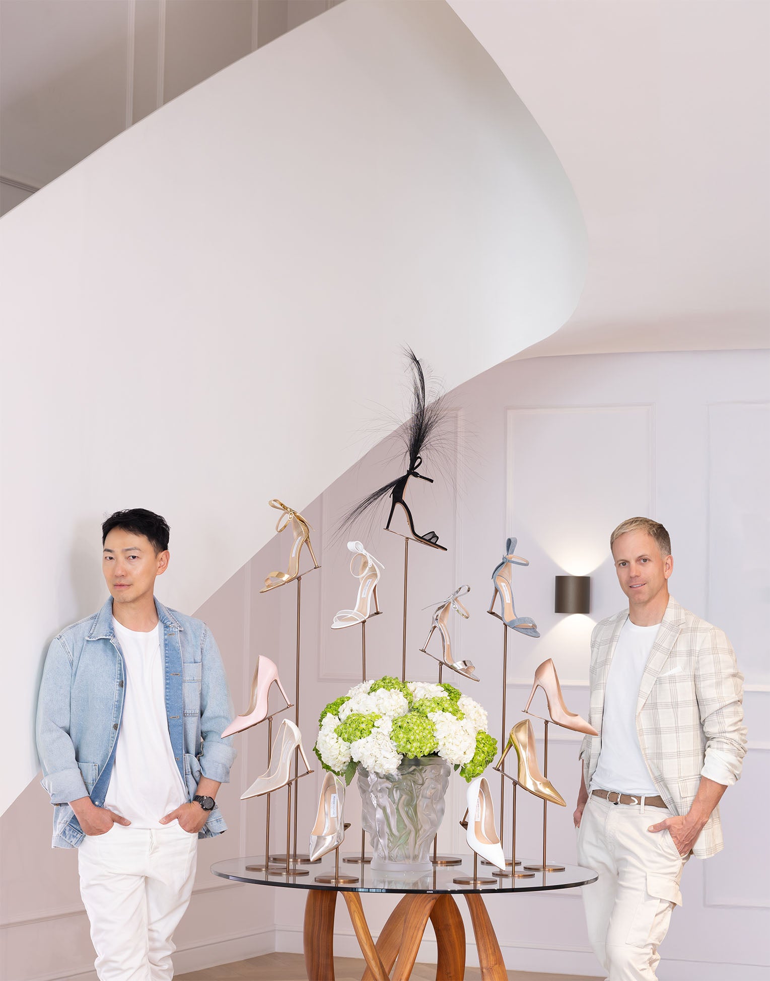 The designers for BUDISM COUTURE next to a table with their shoes